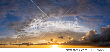 Getting dark at sundown. Sunset sky with scattered clouds of bright colors 136366892