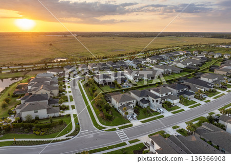 Expensive mansions between green palm trees in southwest Florida suburbs, USA. Aerial view of wealthy residential neighborhood Expensive mansions between green palm trees in southwest Florida suburbs, USA. Aerial view of wealthy residential neighborhood 136366908