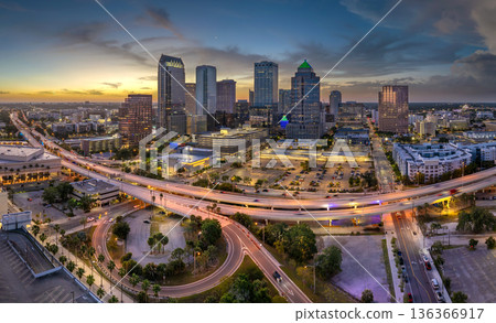 Downtown of Tampa city in Florida, USA. Car traffic on highway road and brightly illuminated high skyscraper buildings. American travel destination 136366917