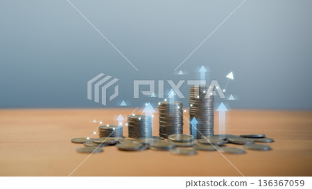 Stacks of coins with glowing upward arrows and graph line, symbolizing financial growth, investment success, business profit increase, economic expansion, and wealth accumulation in modern finance. 136367059
