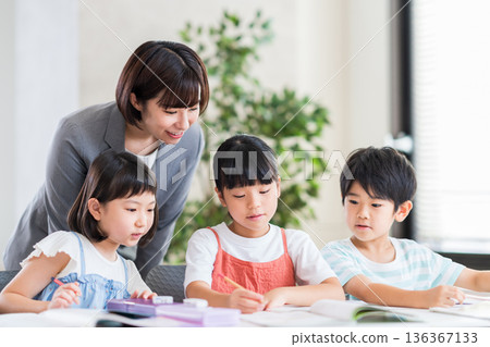 Elementary school students studying at cram school. Elementary school students studying at cram school. 136367133