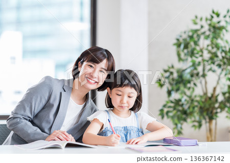 Elementary school students studying at cram school. 136367142