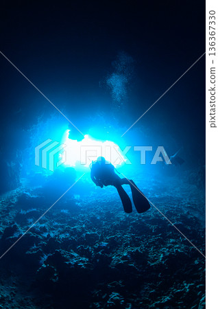 Faint light shining into an underwater cave, Palau, diving scene Faint light shining into an underwater cave, Palau, diving scene 136367330