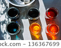 Top view of colorful food dye glass jars for easter egg dyeing in sunlight 136367699