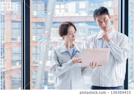 A worker with a troubled expression at a construction site A worker with a troubled expression at a construction site 136369433