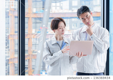 A worker with a troubled expression at a construction site A worker with a troubled expression at a construction site 136369434
