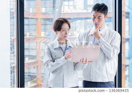 A worker with a troubled expression at a construction site A worker with a troubled expression at a construction site 136369435