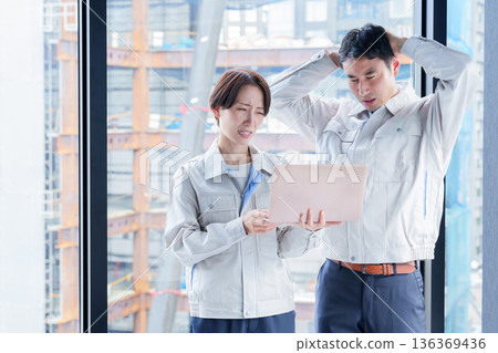 A worker with a troubled expression at a construction site A worker with a troubled expression at a construction site 136369436
