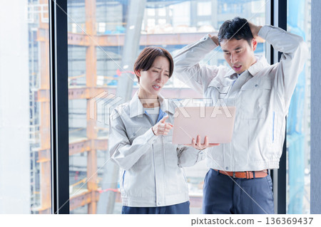 A worker with a troubled expression at a construction site A worker with a troubled expression at a construction site 136369437