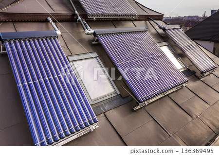 Solar water heating system on house roof. Hot water boiler, alternative ecological sun energy generator. Modern technology concept. 136369495