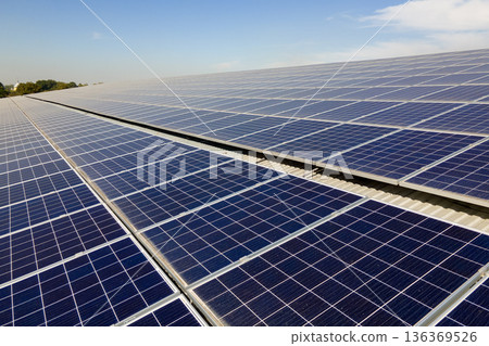 Solar rooftop on commercial structure. Photovoltaic panels for producing of clean ecological electrical energy. Concept of autonomous building Solar rooftop on commercial structure. Photovoltaic panels for producing of clean ecological electrical energy. Concept of autonomous building 136369526