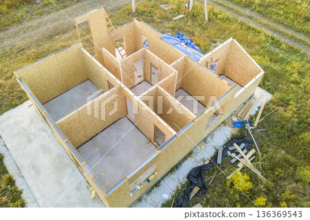 Construction of new and modern modular house. Walls made from composite wooden sip panels with styrofoam insulation inside. Building new frame of energy efficient home concept. Construction of new and modern modular house. Walls made from composite wooden sip panels with styrofoam insulation inside. Building new frame of energy efficient home concept. 136369543