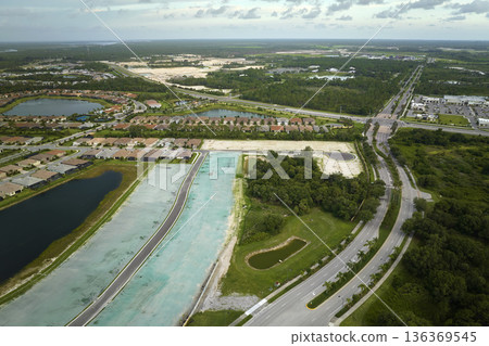 Real estate development with tightly located family houses under construction in Florida suburban area. Concept of growing american suburbs 136369545