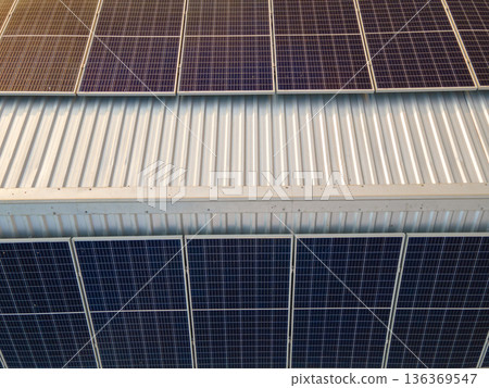 Photovoltaic panels for producing clean ecological electric energy. Commercial building with solar roof. Renewable electricity with zero emission concept. 136369547