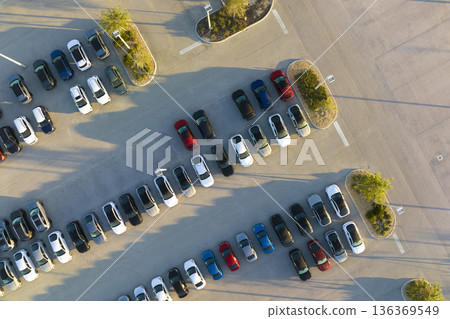 Aerial view of dealership parking lot with many brand new cars for sale. Development of american automotive industry concept Aerial view of dealership parking lot with many brand new cars for sale. Development of american automotive industry concept 136369549
