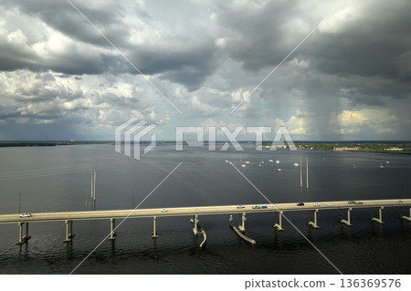 Barron Collier Bridge and Gilchrist Bridge in Florida with moving traffic. Transportation infrastructure in Charlotte County connecting Punta Gorda and Port Charlotte over Peace River 136369576