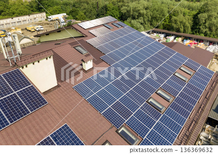 Aerial view of many solar panels mounted of industrial building roof. 136369632