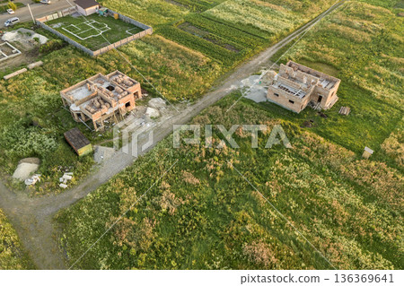 Aerial view of building site for future house, brick basement floor and stacks of brick for construction. Aerial view of building site for future house, brick basement floor and stacks of brick for construction. 136369641