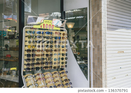 In-store sales of sunglasses, display in an eyeglass store, sales floor with price display In-store sales of sunglasses, display in an eyeglass store, sales floor with price display 136370791