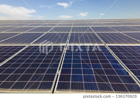 Photovoltaic panels on solar rooftops of commercial building for producing clean ecological electrical energy. Renewable electricity with zero emission concept 136370920