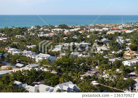 Premium housing development in the USA. Expensive waterfront houses between green palm trees in Boca Grande, small town on Gasparilla Island in southwest Florida 136370927