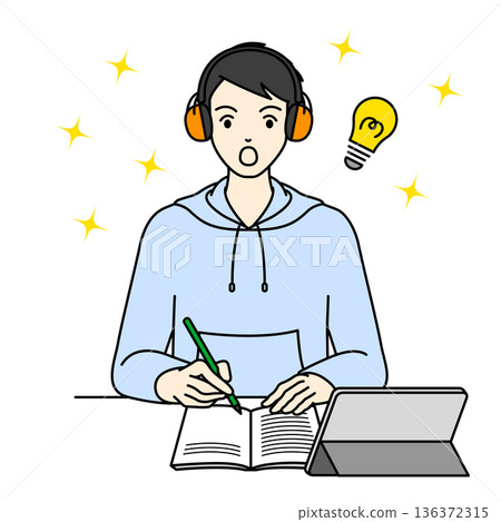 A male high school student concentrates on his studies while wearing earmuffs to combat hyperacusis. 136372315