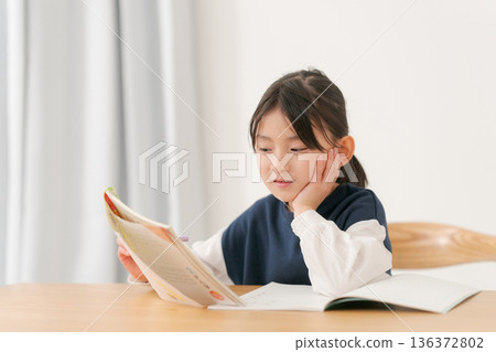 Elementary school girl studying Elementary school girl studying 136372802