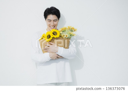 Man with sunflower Man with sunflower 136373076