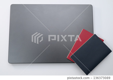 Aerial view of laptop and passport Aerial view of laptop and passport 136373089