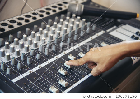 Production sound engineer woman hands adjusting volume equalizer voice, mixing console. DJ sound engineering working on recording studio mixing voice control. Producer remix tune music sound record Production sound engineer woman hands adjusting volume equalizer voice, mixing console. DJ sound engineering working on recording studio mixing voice control. Producer remix tune music sound record 136373150