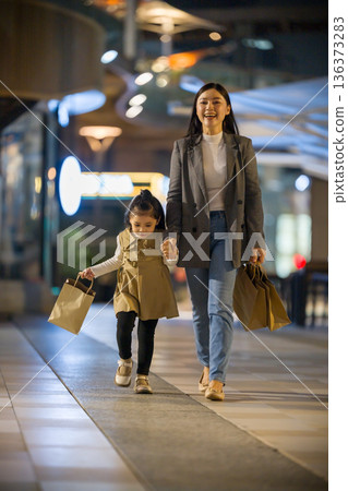 mother and child girl wolking with shopping bag and sightseeing in Bangkok city at night mother and child girl wolking with shopping bag and sightseeing in Bangkok city at night 136373283