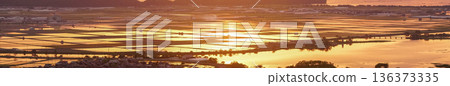 從滋賀縣東近江市豬子町的豬子山上眺望，傍晚時分，稻田在播種前的夕陽映照下泛著橙紅的光芒。 136373335