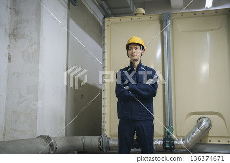 Male building maintenance staff in his 30s wearing work clothes Male building maintenance staff in his 30s wearing work clothes 136374671