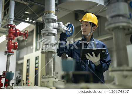 Building maintenance staff carrying out inspection work with a tablet 136374897