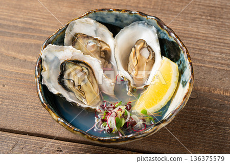 Steamed oysters in sake - a Japanese seafood dish that brings out the delicious flavor Steamed oysters in sake - a Japanese seafood dish that brings out the delicious flavor 136375579