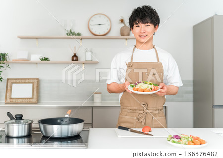 Young Asian man cooking in the kitchen 136376482