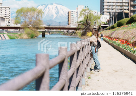 Woman tourist sightseeing Iwate mountain and Kitakami river with flowers in Spring, happy traveler travel in Morioka city, Iwate prefecture, Japan. famous Landmark Travel and Vacation destination 136376941