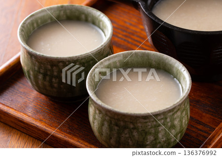 Drinking amazake 136376992