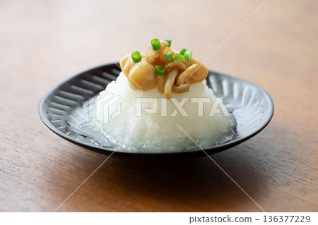 Grated nameko mushrooms on a black plate Grated nameko mushrooms on a black plate 136377229