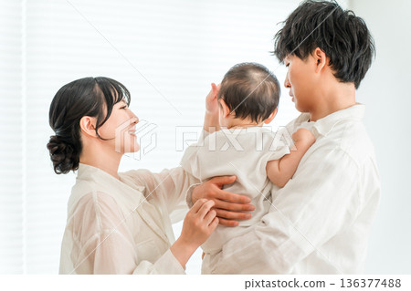 Young Asian couple holding a baby at home, family, parent and child, family Young Asian couple holding a baby at home, family, parent and child, family 136377488