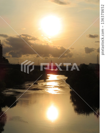 Sunsets reflected on the river Sunsets reflected on the river 136378652