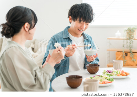 Young Asian couple eating at the dining table in their home 136378687