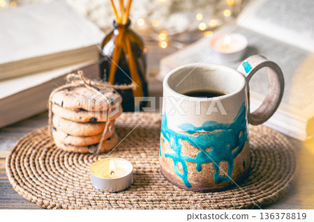 Cozy autumn composition with a handmade cup close-up. 136378819