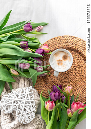 Cozy composition with flowers and coffee on a white background, top view. Cozy composition with flowers and coffee on a white background, top view. 136378828