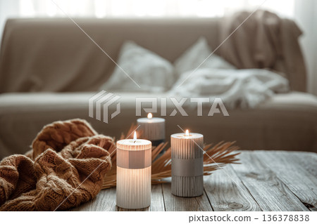 Flaming candles on the table in the interior of the room. Flaming candles on the table in the interior of the room. 136378838