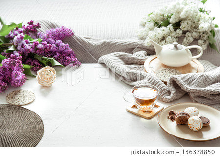 Cozy spring composition with tea and blooming lilac. Cozy spring composition with tea and blooming lilac. 136378850