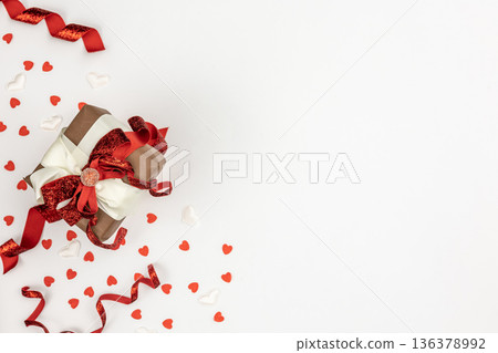 Flat lay, white background with gift box and valentine's day decor details. 136378992