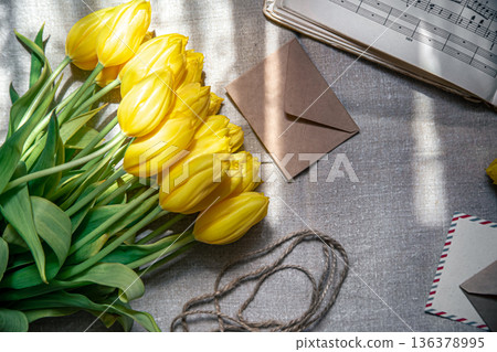 Flat lay, yellow tulips, envelopes and music notes. 136378995