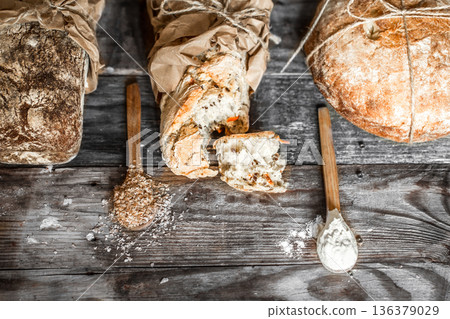fresh bread and wooden spoon on old wooden background 136379029