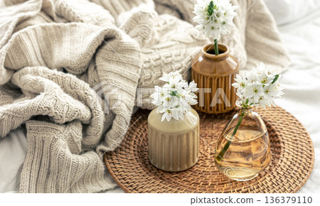 Home composition with flowers in vases and a knitted element. Home composition with flowers in vases and a knitted element. 136379110